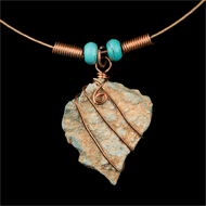 Rough turquoise wrapped in copper on recycled guitar string