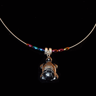 Hematite turtle on a guitar string