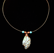 Turquoise wrapped in copper on guitar string
